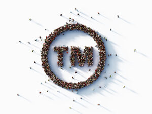 Human crowd forming trademark symbol on white background. Horizontal composition with copy space.