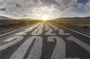 desert landscape with the years 2021, 2022, 2023, 2024 and 2025 painted in white on the road.